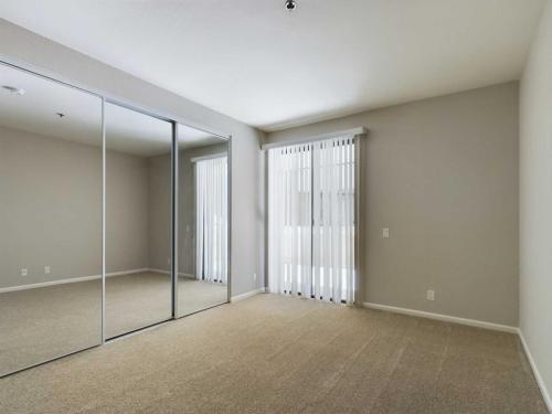 Apartments in Hancock Park, CA An empty room with beige carpet, white walls, a window with vertical blinds, and a mirrored closet door. Chelsea Court Apartments in Hancock Park 500 North Rossmore Avenue Hancock Park, CA 90004  P: 833-918-2899 TTY:711 F: 323-446-8466